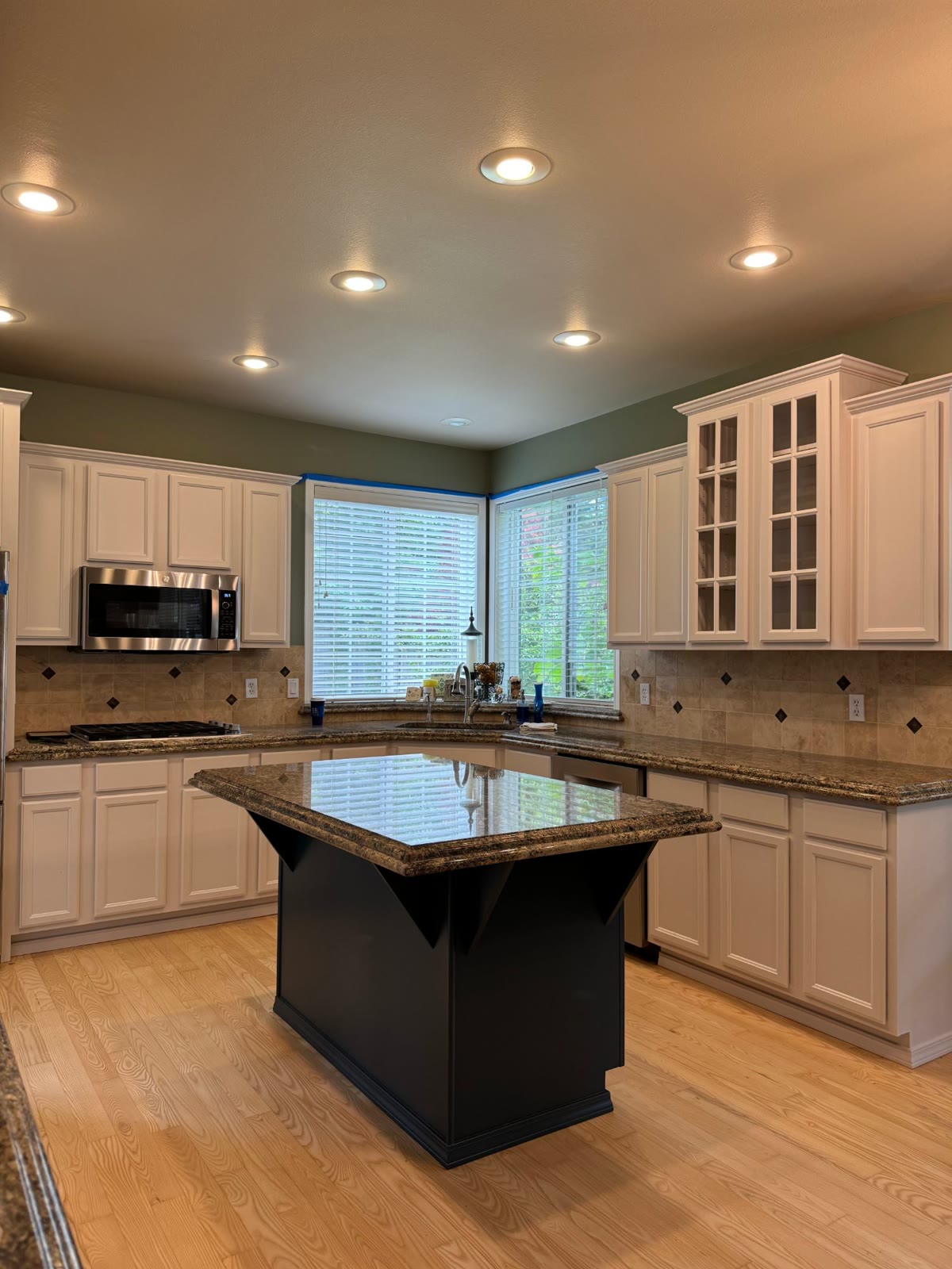 The kitchen after: white cabinets and a navy island