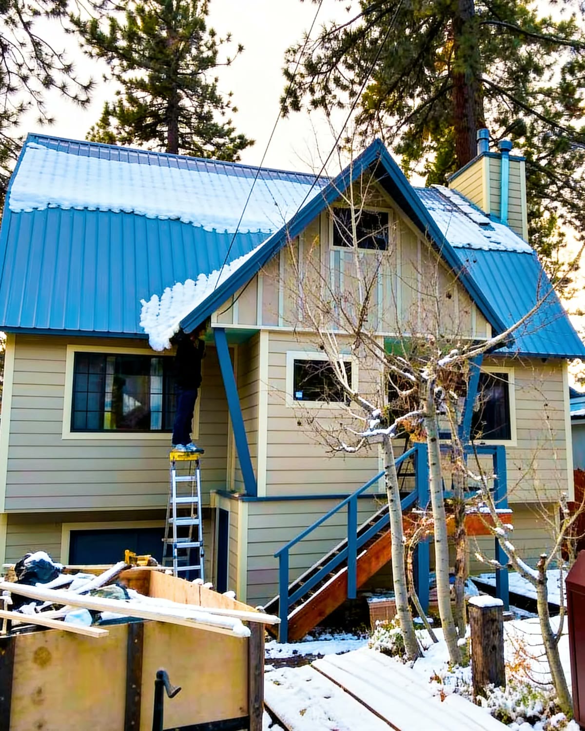 The house before: beige siding and a blue metal roof